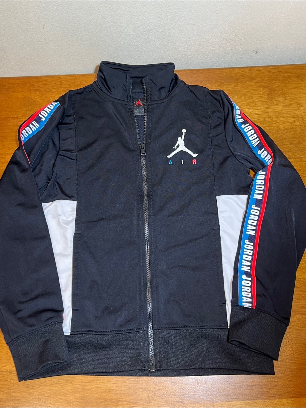 Jordan Black Track Jacket with Red & Blue Sleeve Trim Size M (10-12yrs)